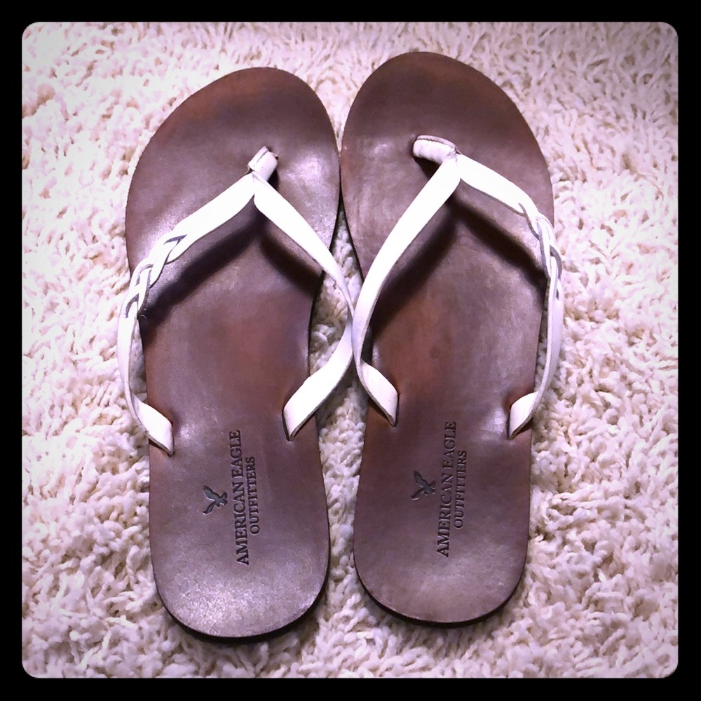 White and leather AE flip flops.